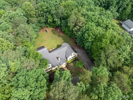 an aerial view of a house with a yard