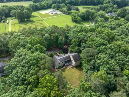 an aerial view of a house with swimming pool outdoor seating and yard