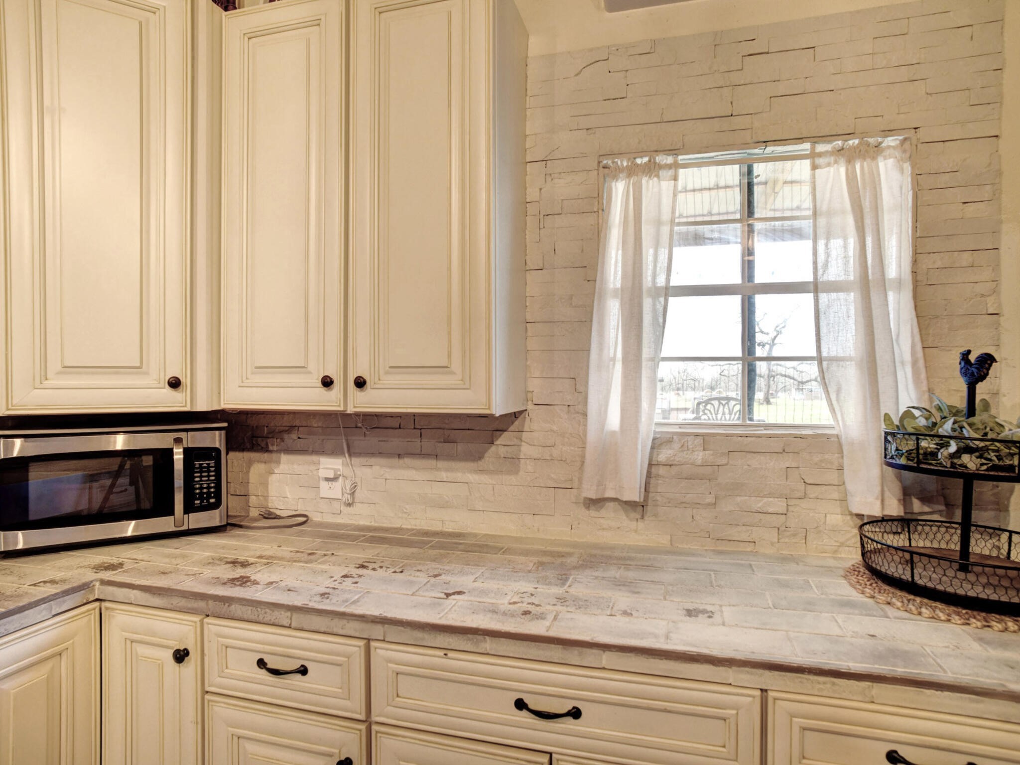3747 Sparta Field Road Flatonia, TX 78941 - Photo 23 of 37 a kitchen with stainless steel appliances granite countertop white cabinets and a window