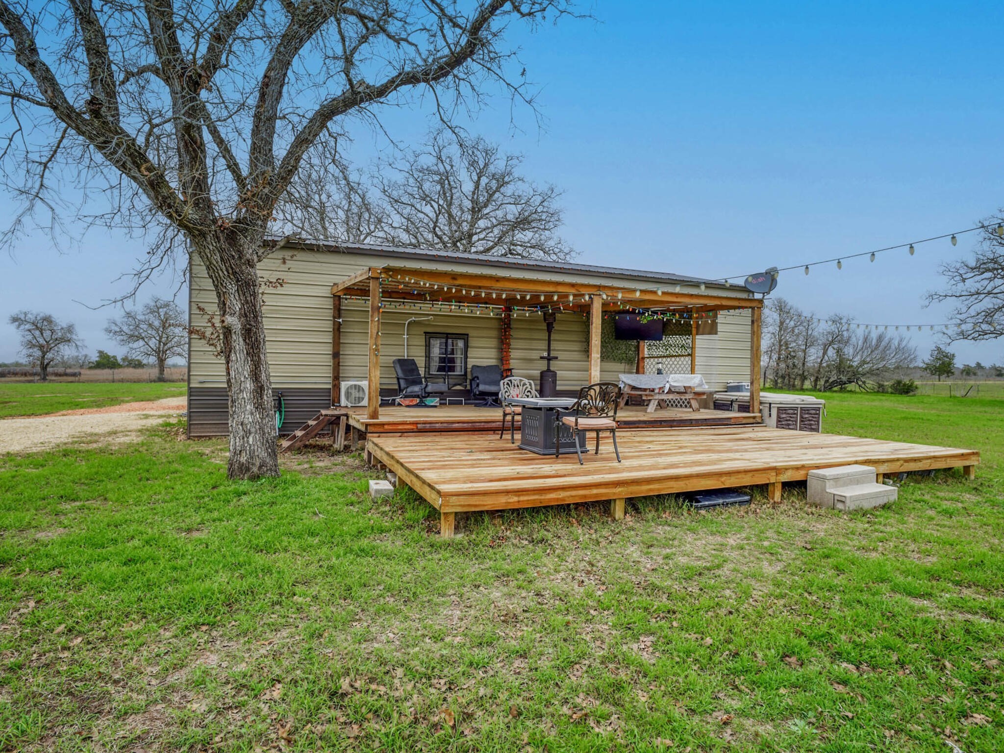 3747 Sparta Field Road Flatonia, TX 78941 - Photo 33 of 37 a front view of a house with garden and swimming pool
