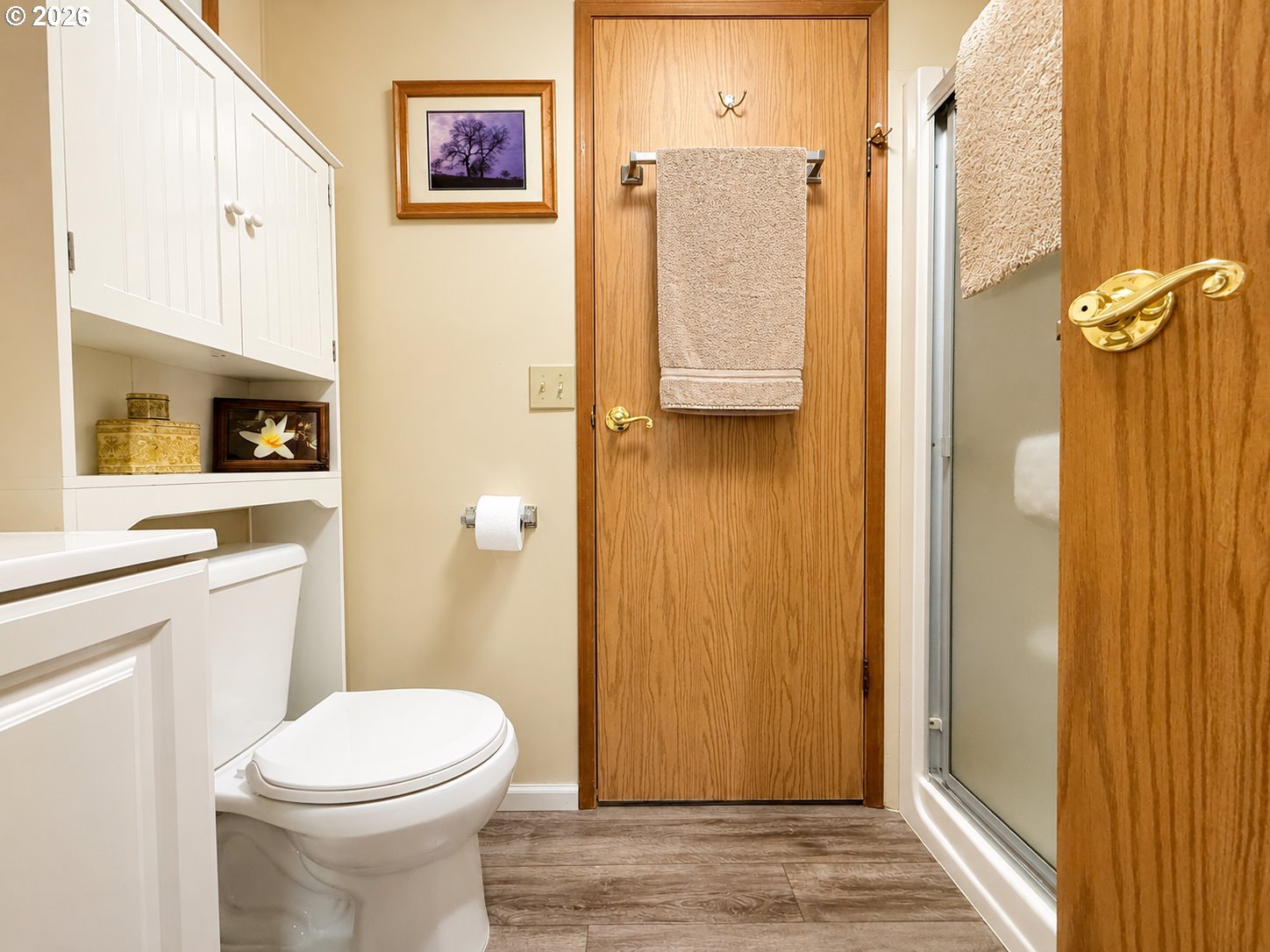 16219 Lower Harbor Road, Unit 16 Brookings, OR 97415 - Photo 22 of 40 a bathroom with a sink a toilet and shower curtain