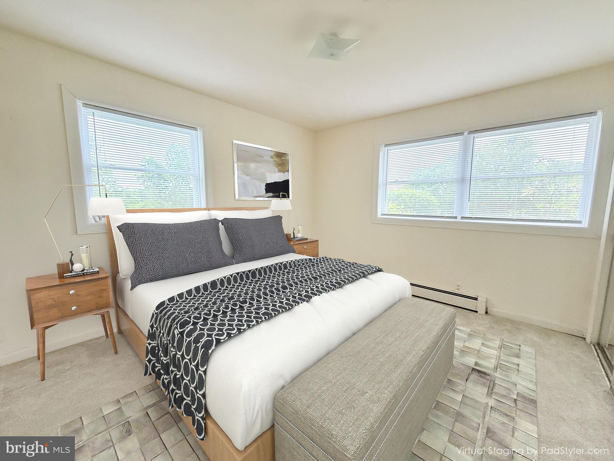 48724 Curleys Road Ridge, MD 20680 - Photo 14 of 47 a bedroom with a large bed and wooden floor