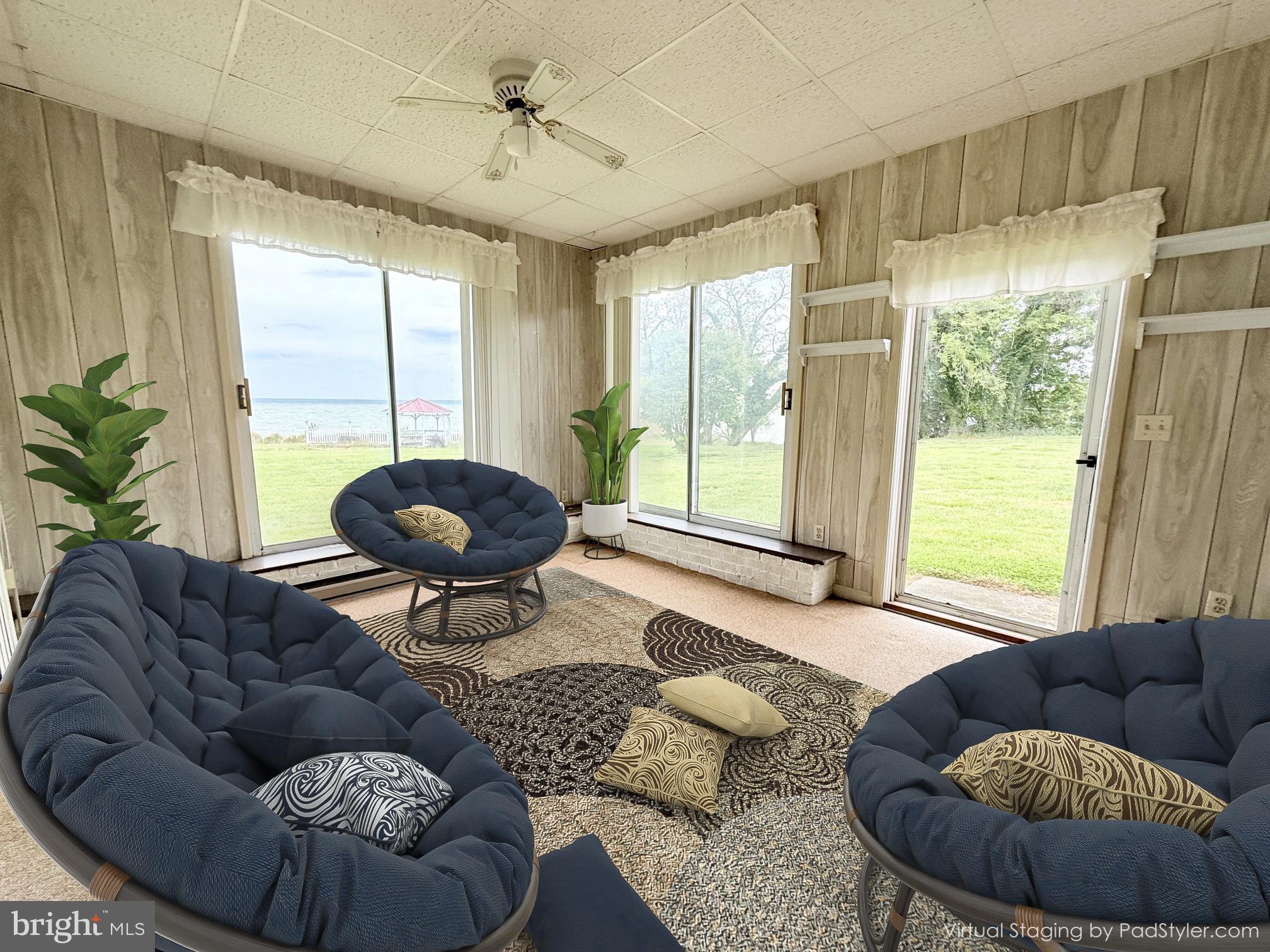 48724 Curleys Road Ridge, MD 20680 - Photo 17 of 47 a living room with furniture and a large window