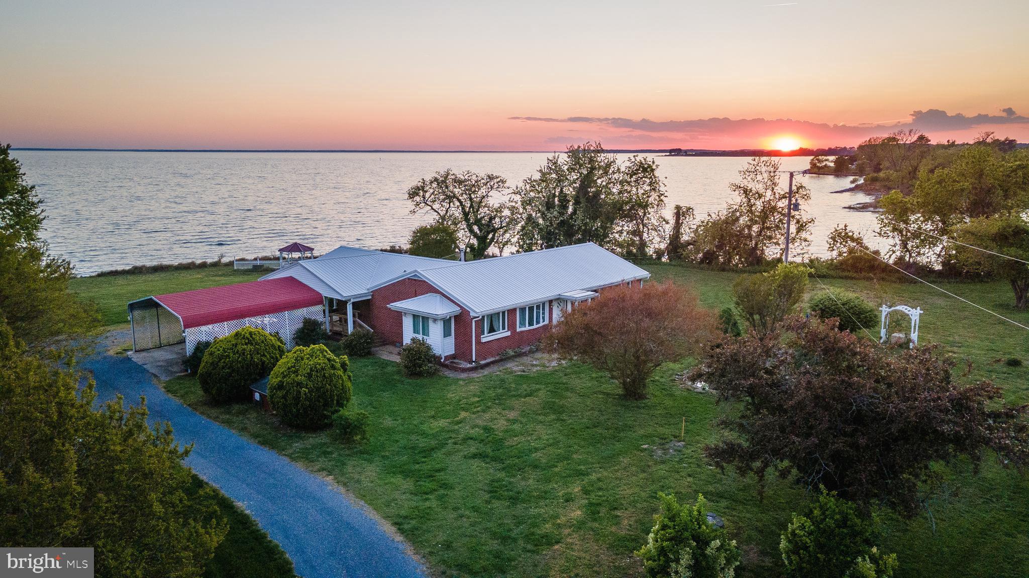 48724 Curleys Road Ridge, MD 20680 - Photo 2 of 47 an aerial view of a house with a yard and lake view