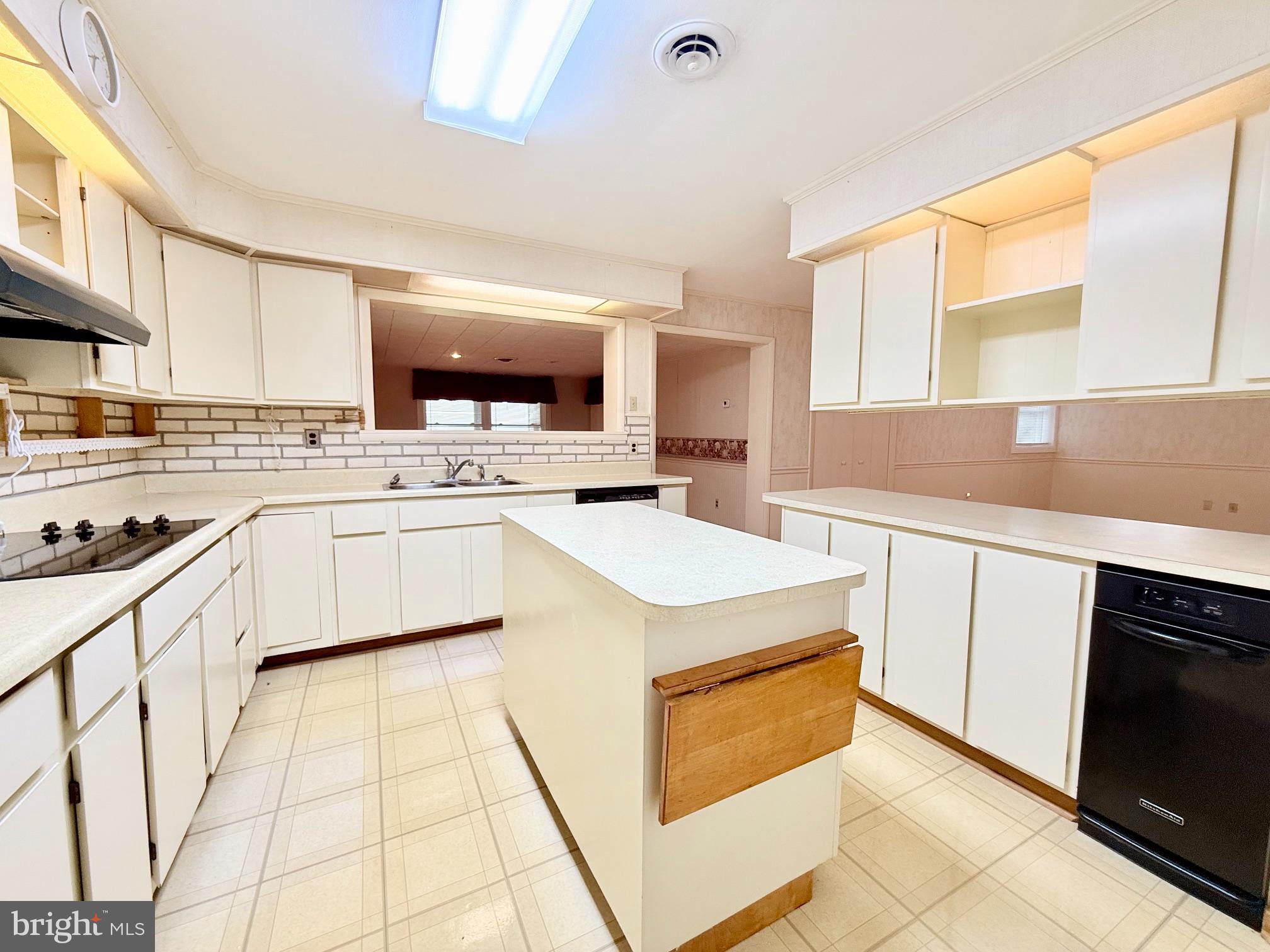 48724 Curleys Road Ridge, MD 20680 - Photo 26 of 47 a kitchen with a stove a sink and a microwave