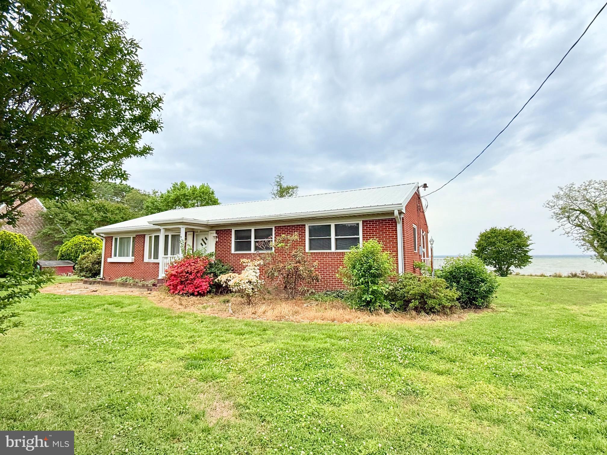 48724 Curleys Road Ridge, MD 20680 - Photo 40 of 47 a front view of a house with garden