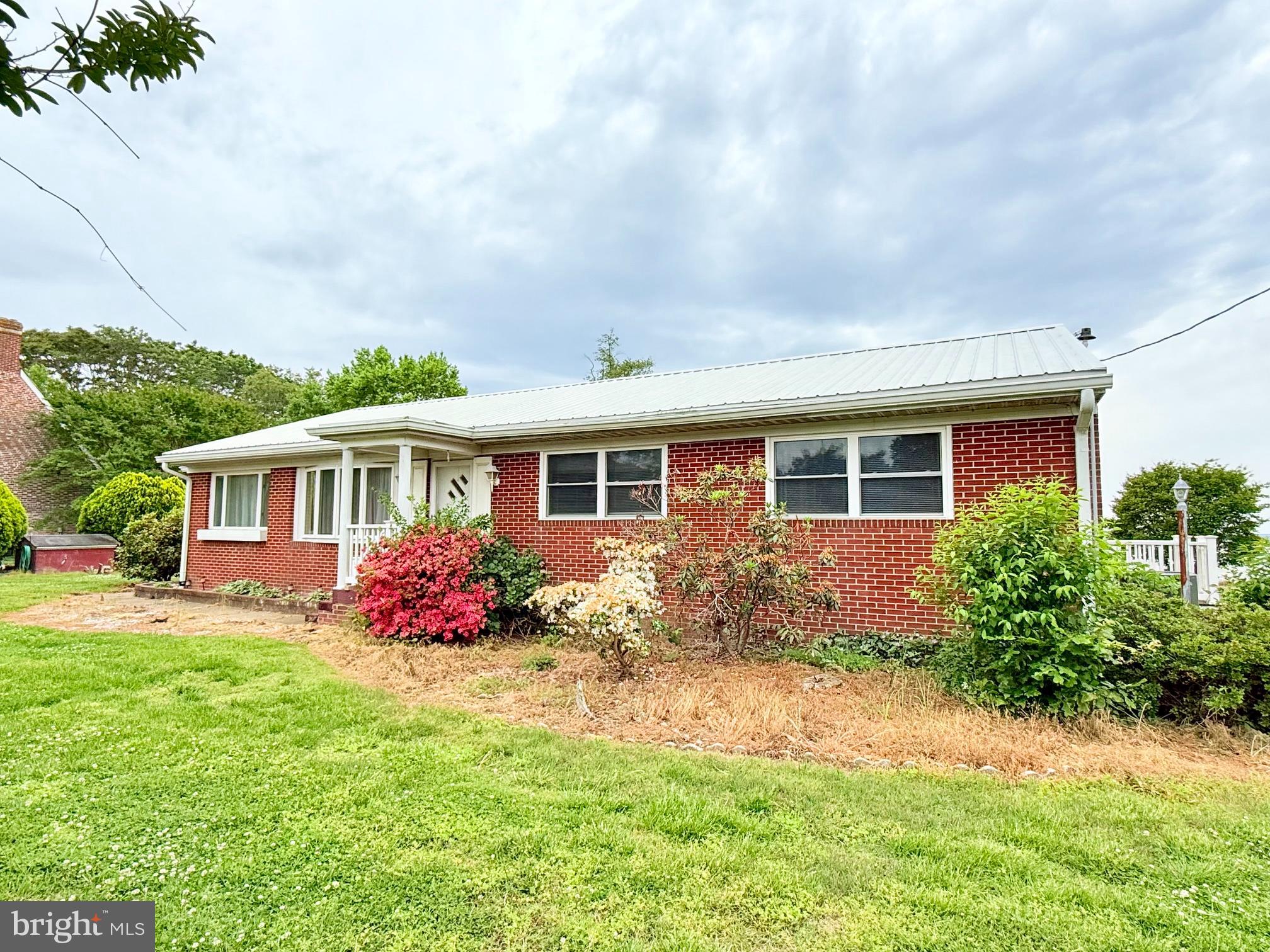 48724 Curleys Road Ridge, MD 20680 - Photo 4 of 47 a front view of a house with a yard