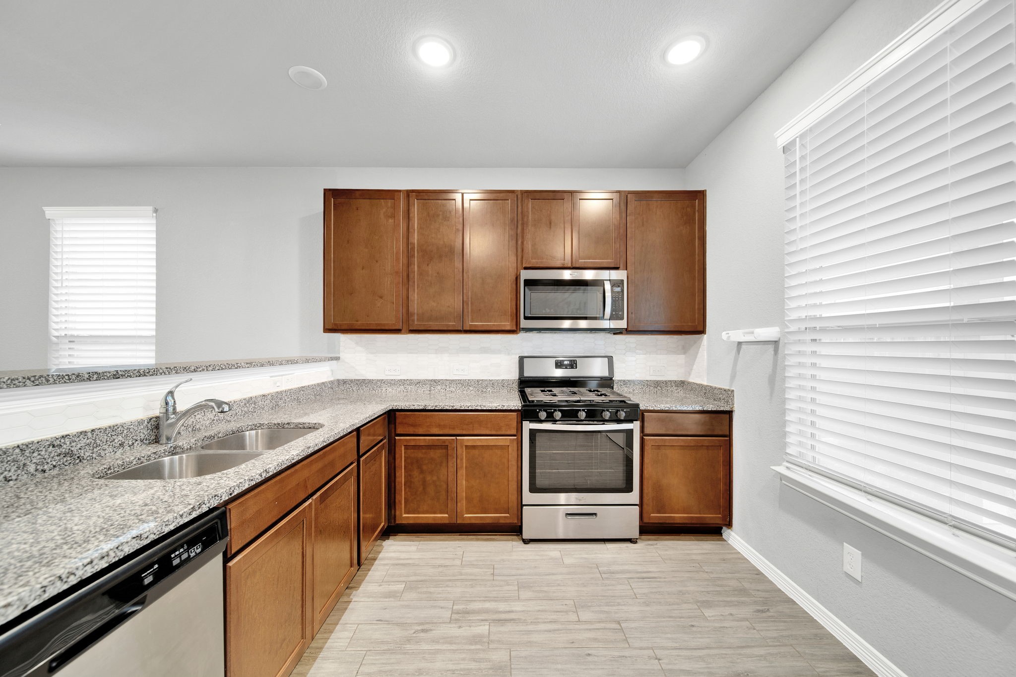 24722 Colony Meadow Trail Houston, TX 77336 - Photo 5 of 16 a kitchen with stainless steel appliances granite countertop a sink stove and refrigerator