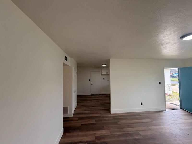8625 La Vaca Way Hanford, CA 93230 - Photo 4 of 20 a view of a room with wooden floor and a hallway