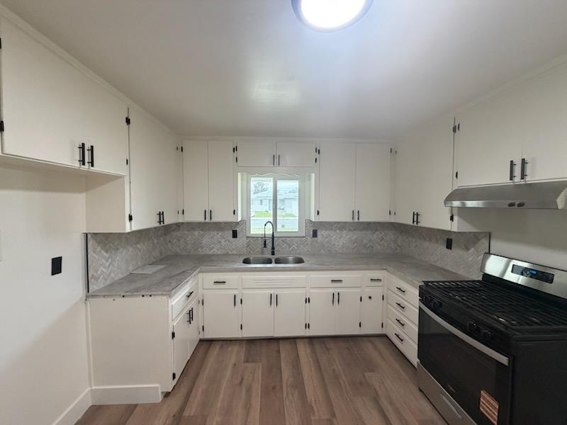 8625 La Vaca Way Hanford, CA 93230 - Photo 6 of 20 a kitchen with granite countertop a sink a stove and cabinets