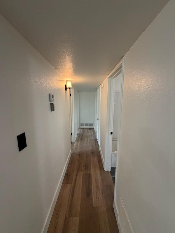 8625 La Vaca Way Hanford, CA 93230 - Photo 10 of 20 a view of a hallway with wooden floor