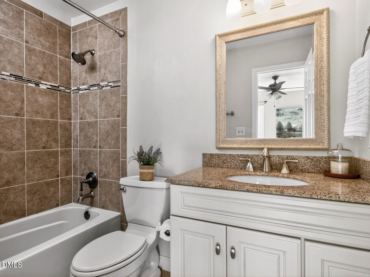 6703 Queen Annes Drive Raleigh, NC 27613 - Photo 12 of 20 a bathroom with a granite countertop toilet a sink and a bathtub