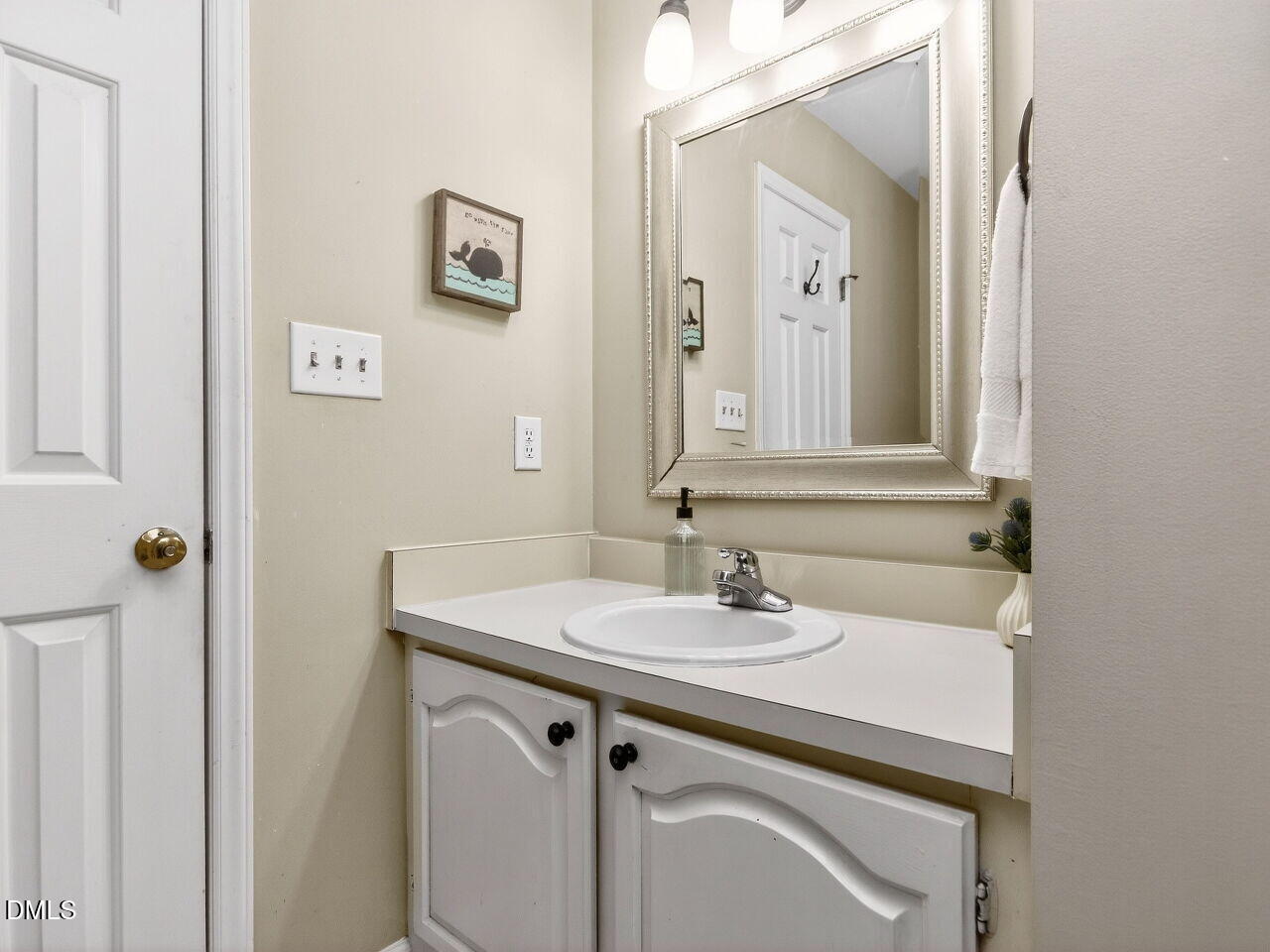 6703 Queen Annes Drive Raleigh, NC 27613 - Photo 14 of 20 a bathroom with a sink and a mirror