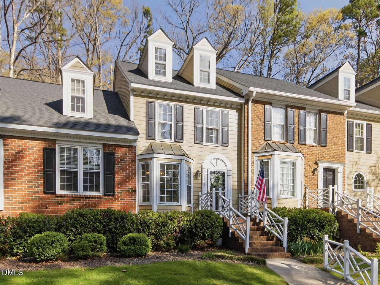 6703 Queen Annes Drive Raleigh, NC 27613 - Photo 3 of 20 a front view of a residential apartment building with a yard and potted plants