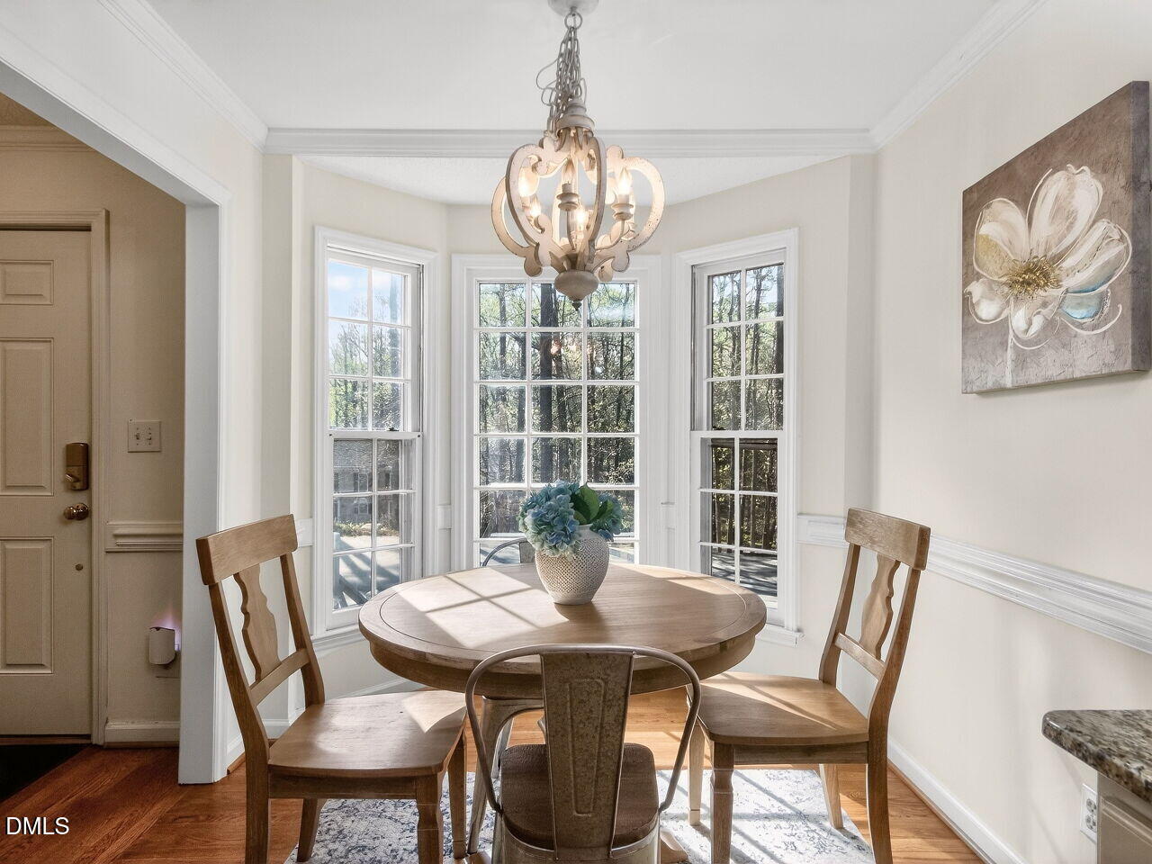 6703 Queen Annes Drive Raleigh, NC 27613 - Photo 5 of 20 a view of a dining room with furniture wooden floor and a chandelier