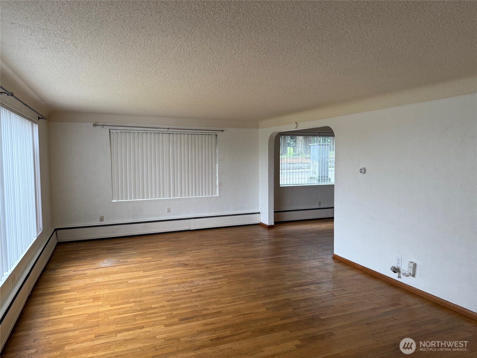 5120 Colby Avenue, Unit 1 Everett, WA 98203 - Photo 3 of 9 an empty room with wooden floor and windows