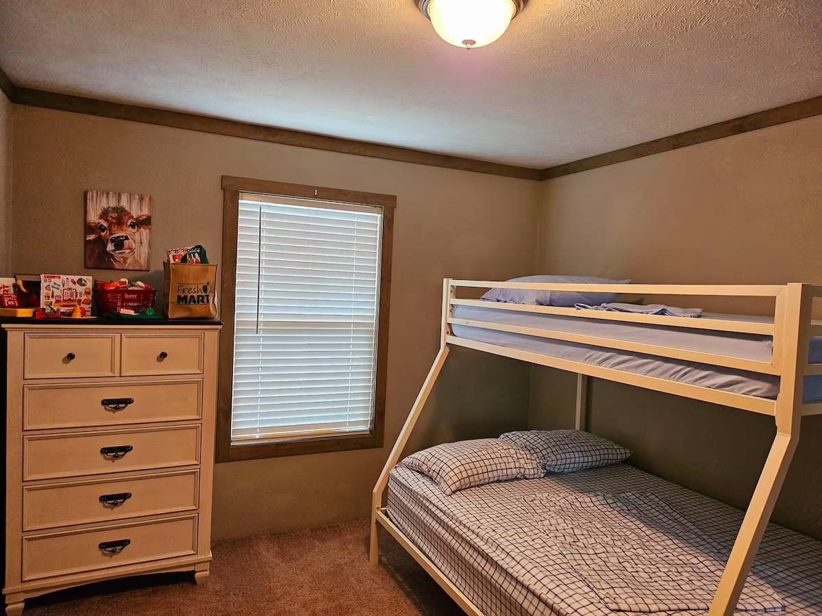 105 Saddle Surrey Road Coldspring, TX 77331 - Photo 29 of 48 a bedroom with a bed and a dresser