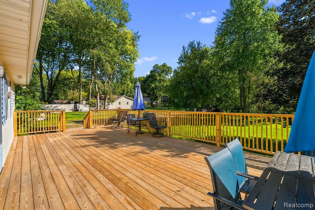 87 Burley Road Columbiaville, MI 48421 - Photo 7 of 31 Expansive wood deck with a natural finish, wood railings, and a direct walk-out