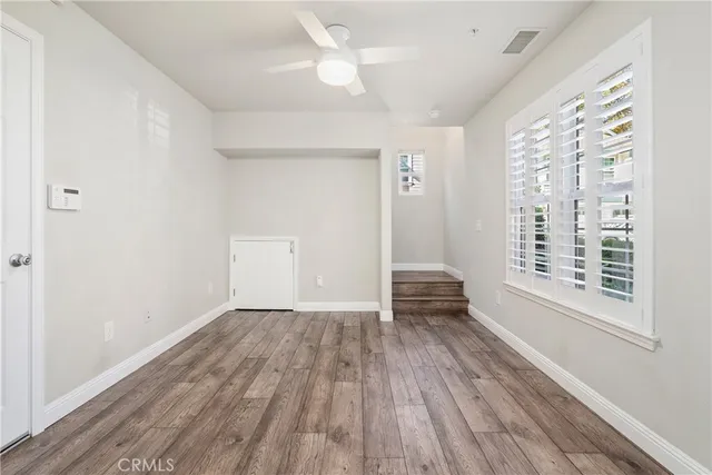 wooden floor in an empty room with a window