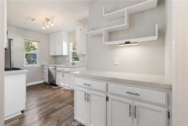 a kitchen with white cabinets and white appliances