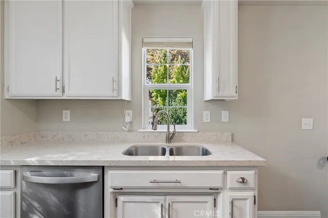 a kitchen with appliances a sink and cabinets
