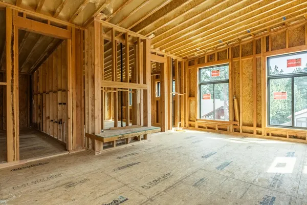 a view of a house with a wooden fence