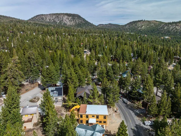 an aerial view of a house with a yard