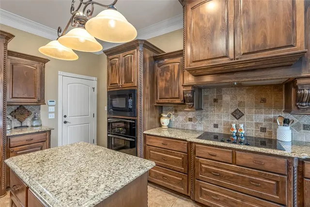 a kitchen with cabinets and stainless steel appliances