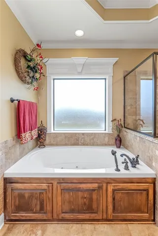 a bathroom with a tub sink and mirror