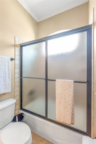 a bathroom with a toilet and a shower