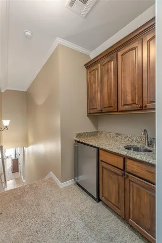 a kitchen with granite countertop cabinets and window