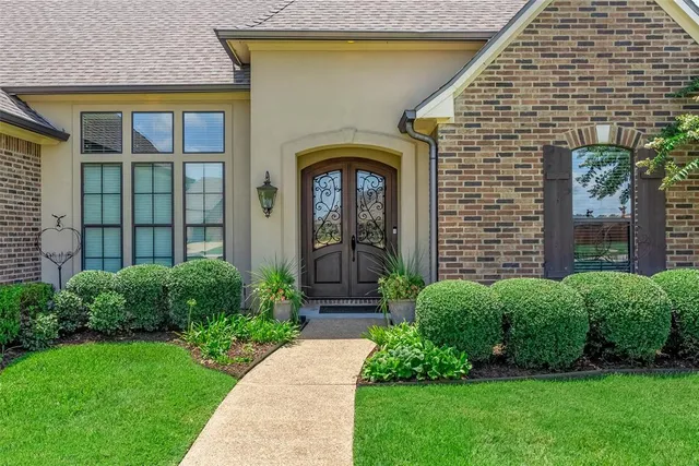a front view of a house with garden