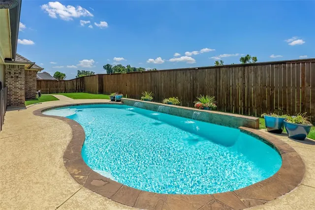 a view of a backyard with swimming pool