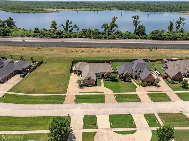 a view of swimming pool with seating space and plants