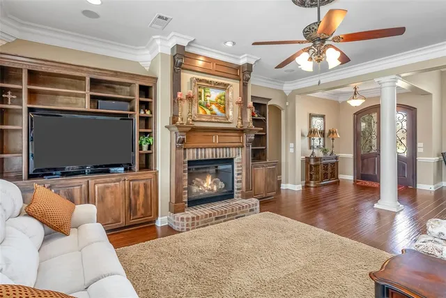 a living room with furniture a flat screen tv and a fireplace
