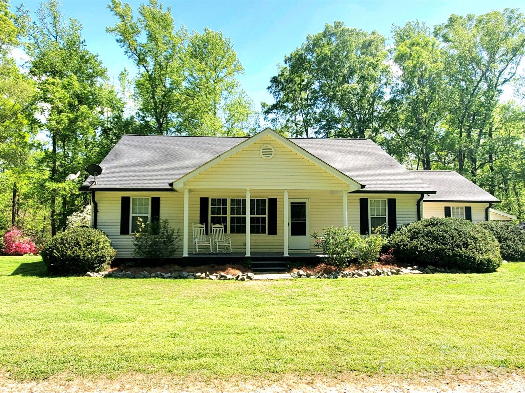 5013 Medlin Road Monroe, NC 28112 - Photo 1 of 30 a front view of a house with a garden