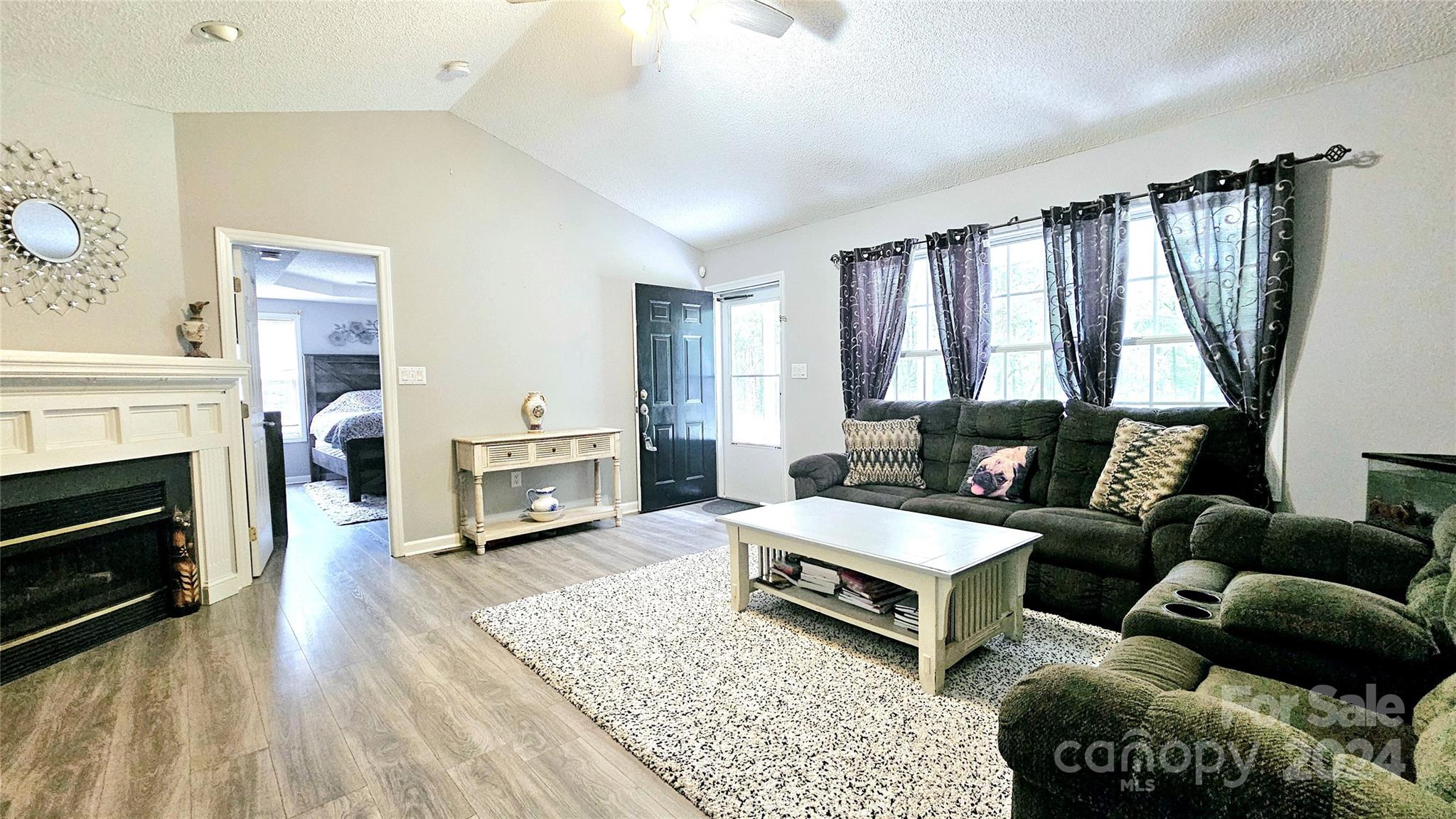 5013 Medlin Road Monroe, NC 28112 - Photo 13 of 30 a living room with furniture and a fireplace