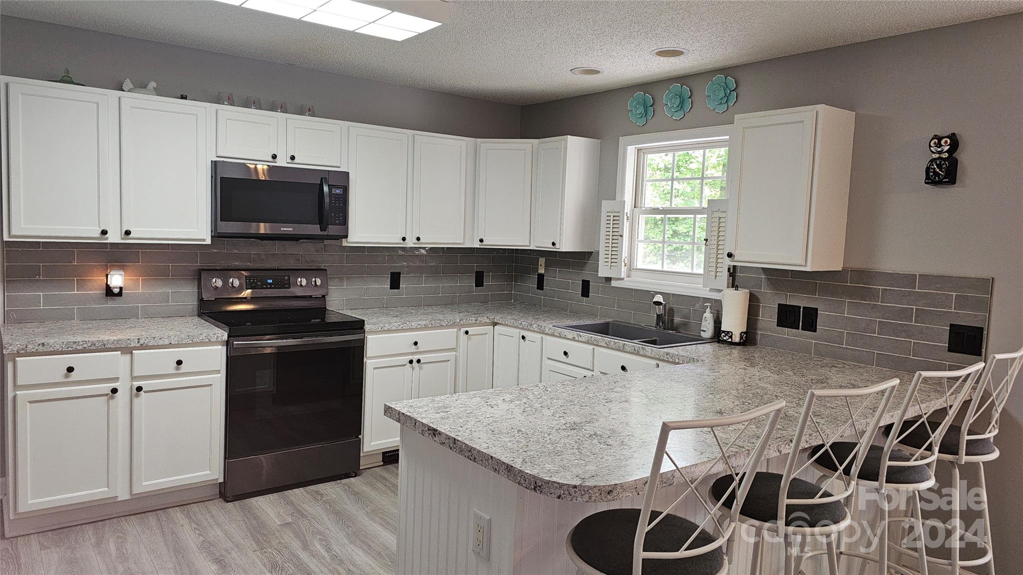 5013 Medlin Road Monroe, NC 28112 - Photo 15 of 30 a kitchen with stainless steel appliances granite countertop a stove sink microwave and cabinets