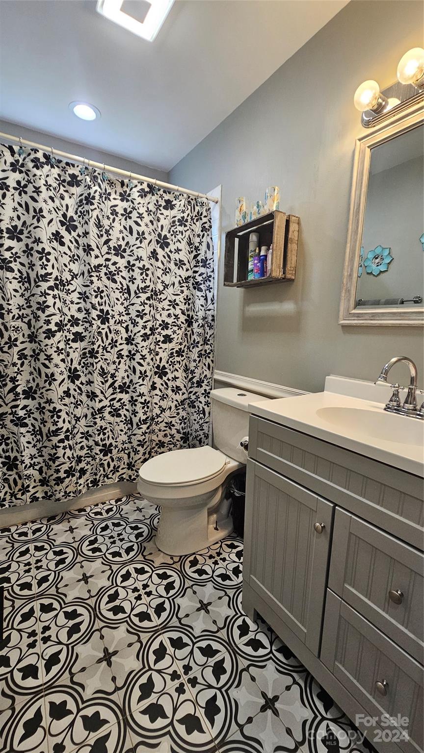 5013 Medlin Road Monroe, NC 28112 - Photo 19 of 30 a bathroom with a sink toilet and shower