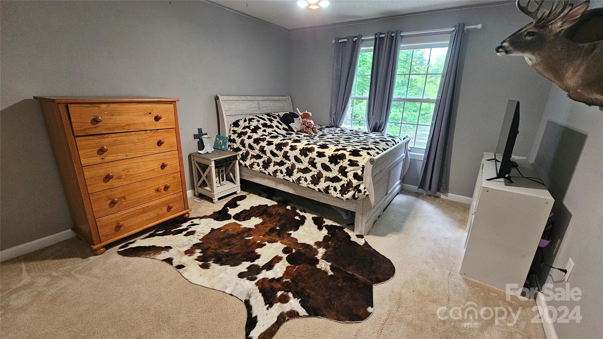 5013 Medlin Road Monroe, NC 28112 - Photo 21 of 30 a bedroom with a bed and wooden floor
