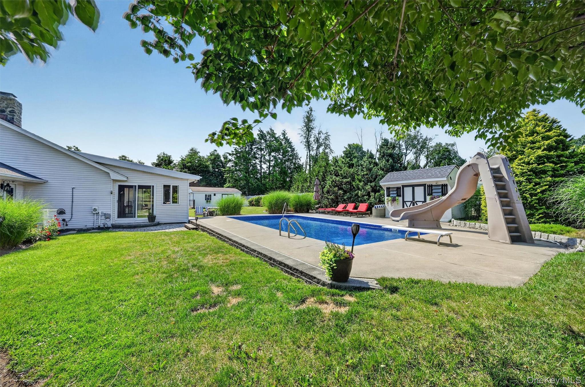 5 Hedges Road Warwick, NY 10990 - Photo 42 of 48 A true backyard retreat with an inground pool, multiple sitting areas, mature trees, privacy fencing, and space designed for summer enjoyment.