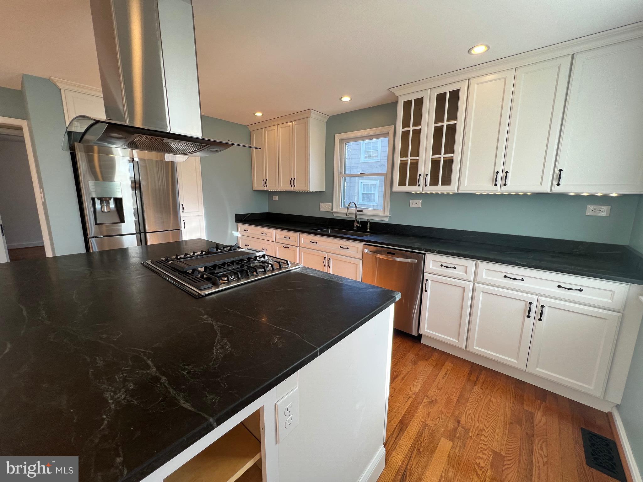 318 Whitestone Road Silver Spring, MD 20901 - Photo 13 of 23 a kitchen with granite countertop a stove a sink and a refrigerator