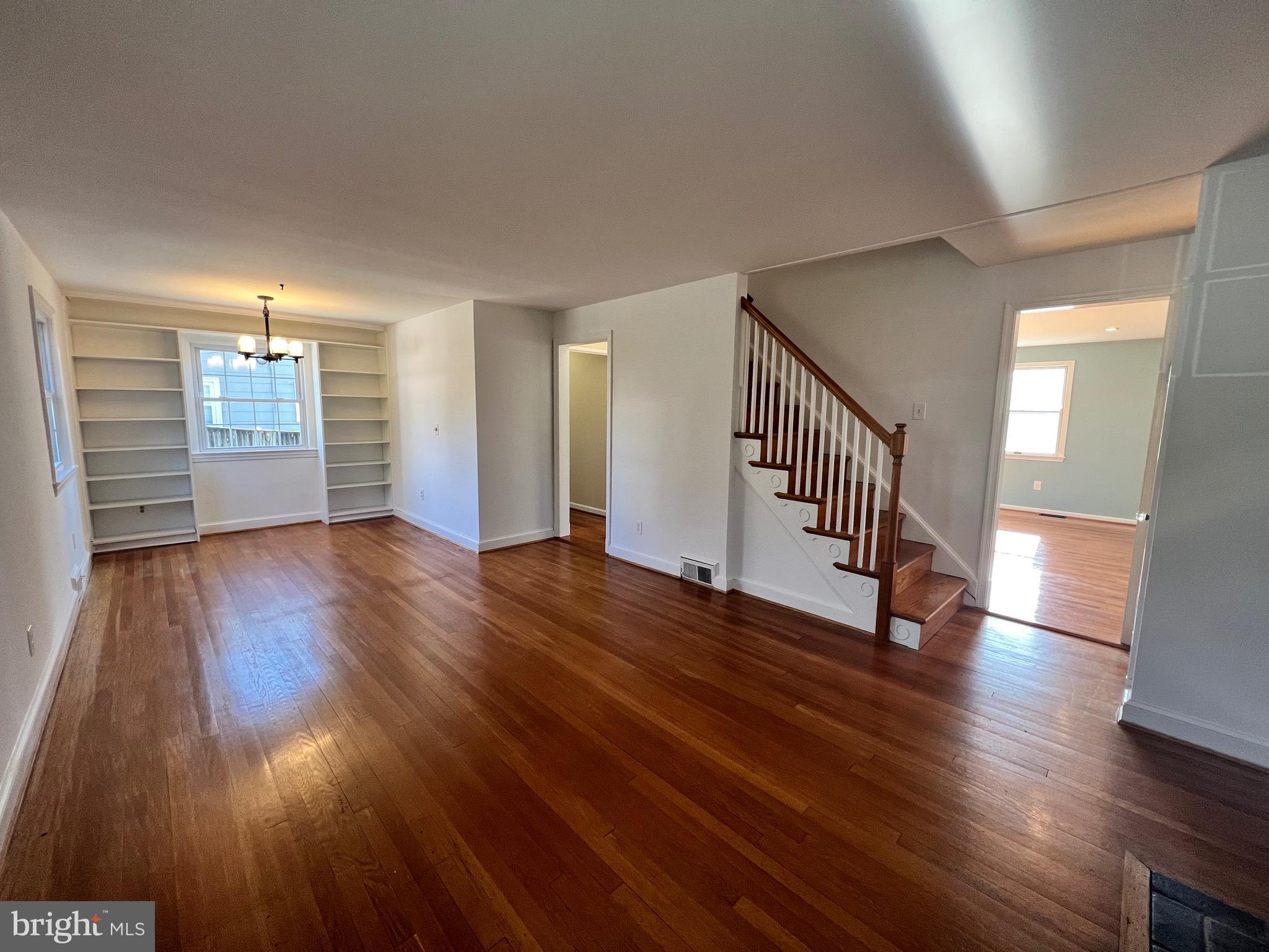 318 Whitestone Road Silver Spring, MD 20901 - Photo 17 of 23 a view of an empty room with wooden floor and stairs