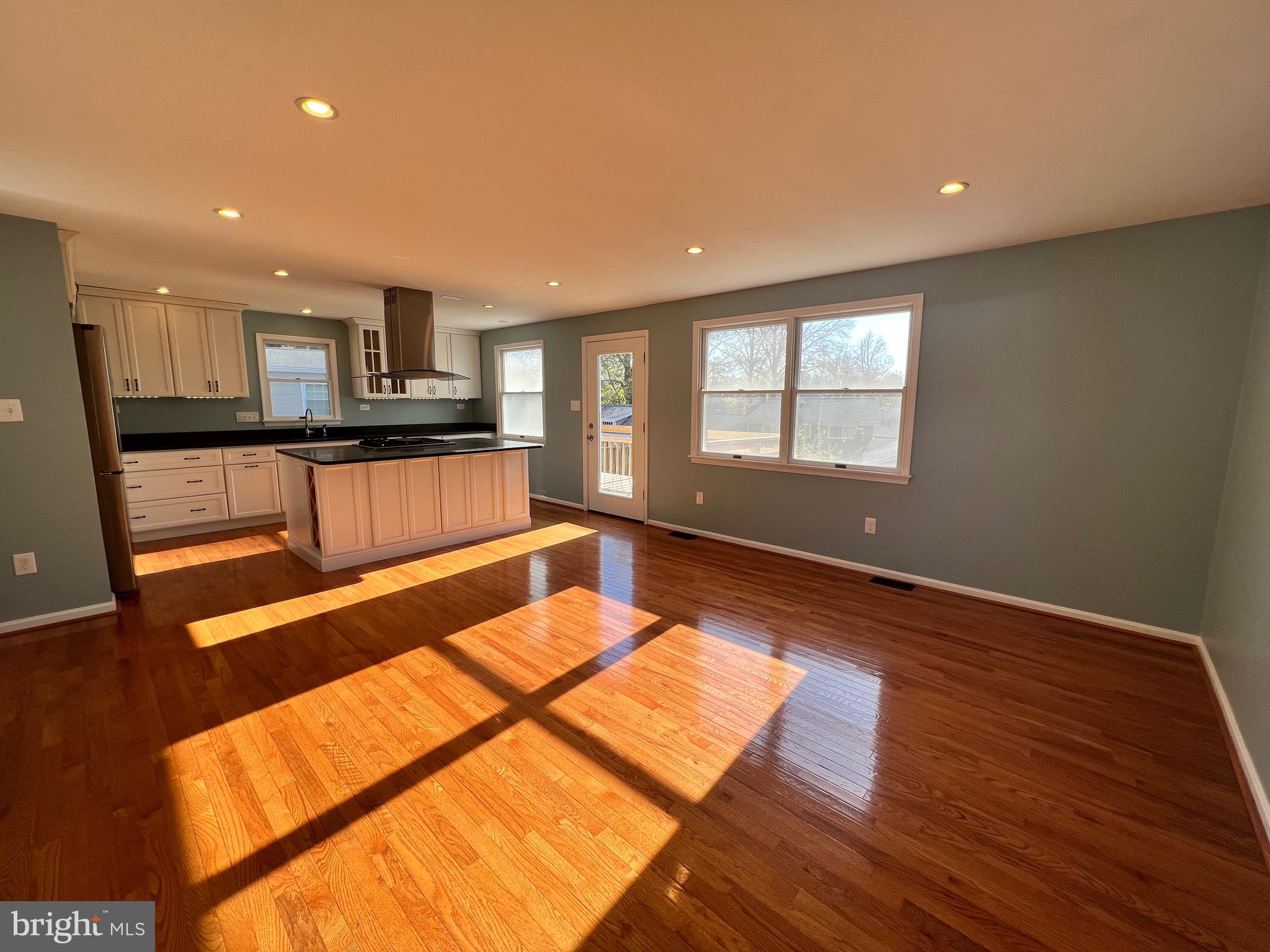 318 Whitestone Road Silver Spring, MD 20901 - Photo 23 of 23 a view of a living room with kitchen furniture and a wooden floor