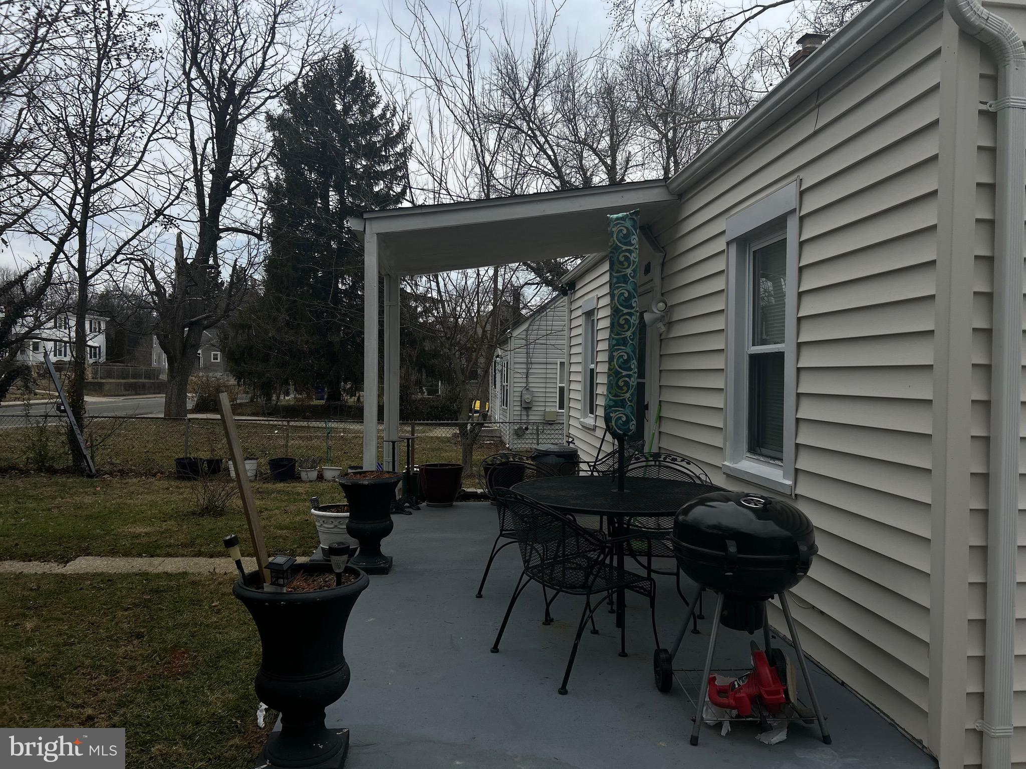 4410 Allies Road Suitland, MD 20746 - Photo 6 of 8 a view of a patio with table and chairs and potted plants with wooden roof and floor
