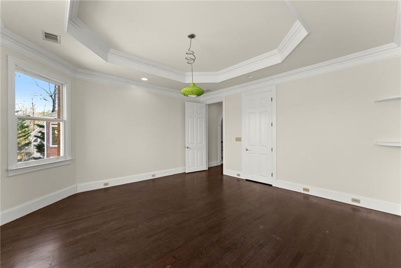 10 Club Court Alpharetta, GA 30005 - Photo 73 of 107 an empty room with wooden floor a ceiling fan and windows