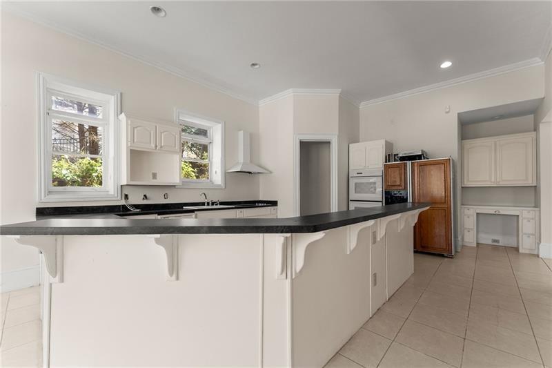 10 Club Court Alpharetta, GA 30005 - Photo 91 of 107 a large kitchen with granite countertop a sink and stainless steel appliances