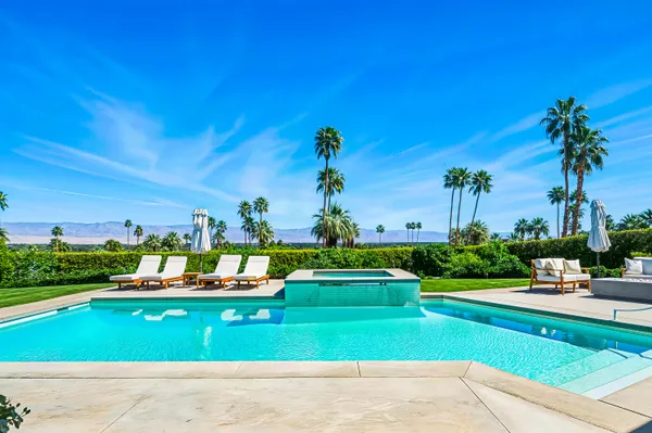 a view of a house with a yard patio and swimming pool