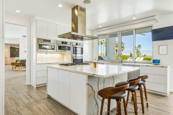 a view of a dining room with furniture water view and balcony
