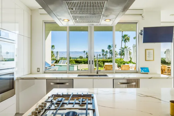 a bathroom with a granite countertop sink a mirror and a shower